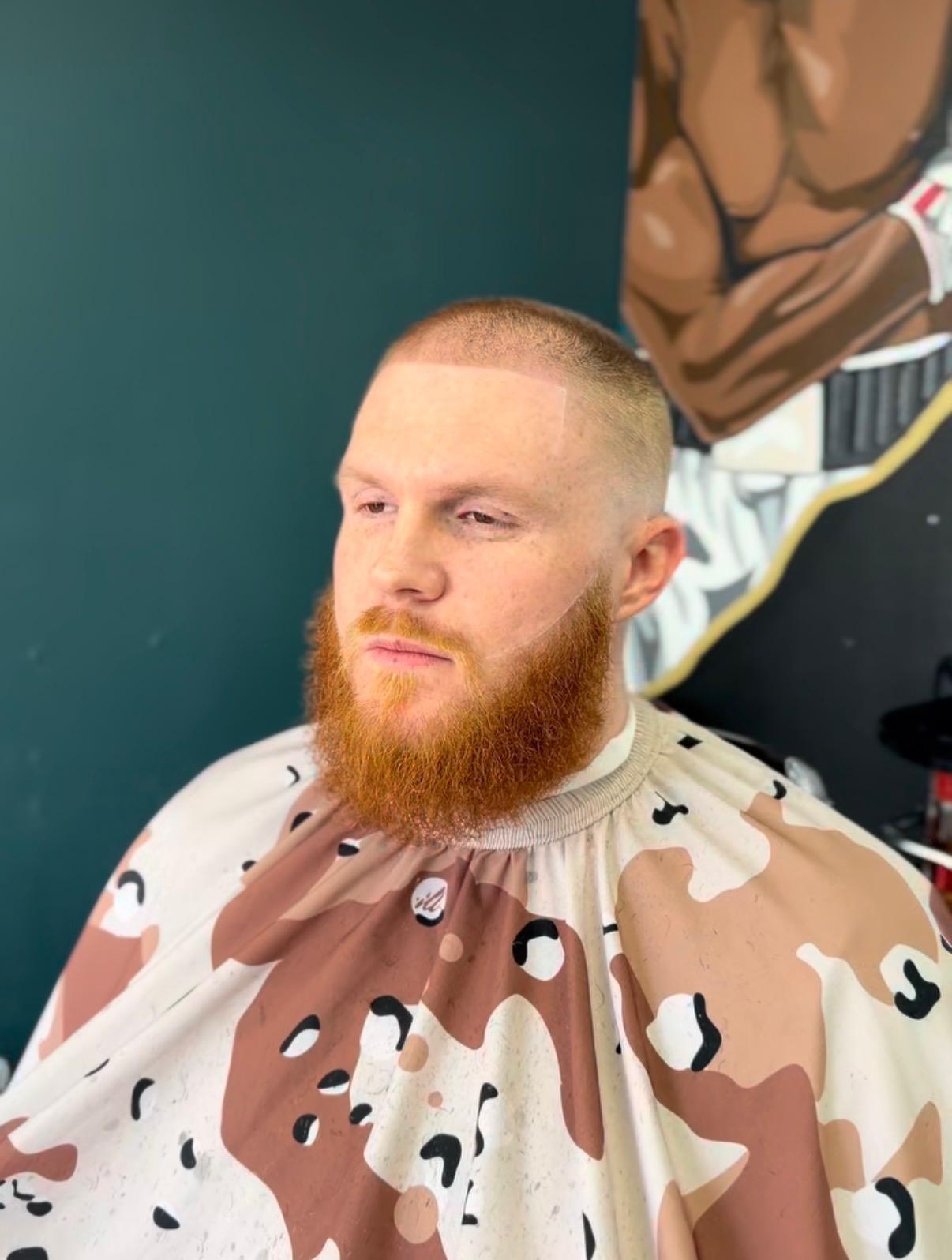 Buzz cut paired with a full ginger beard