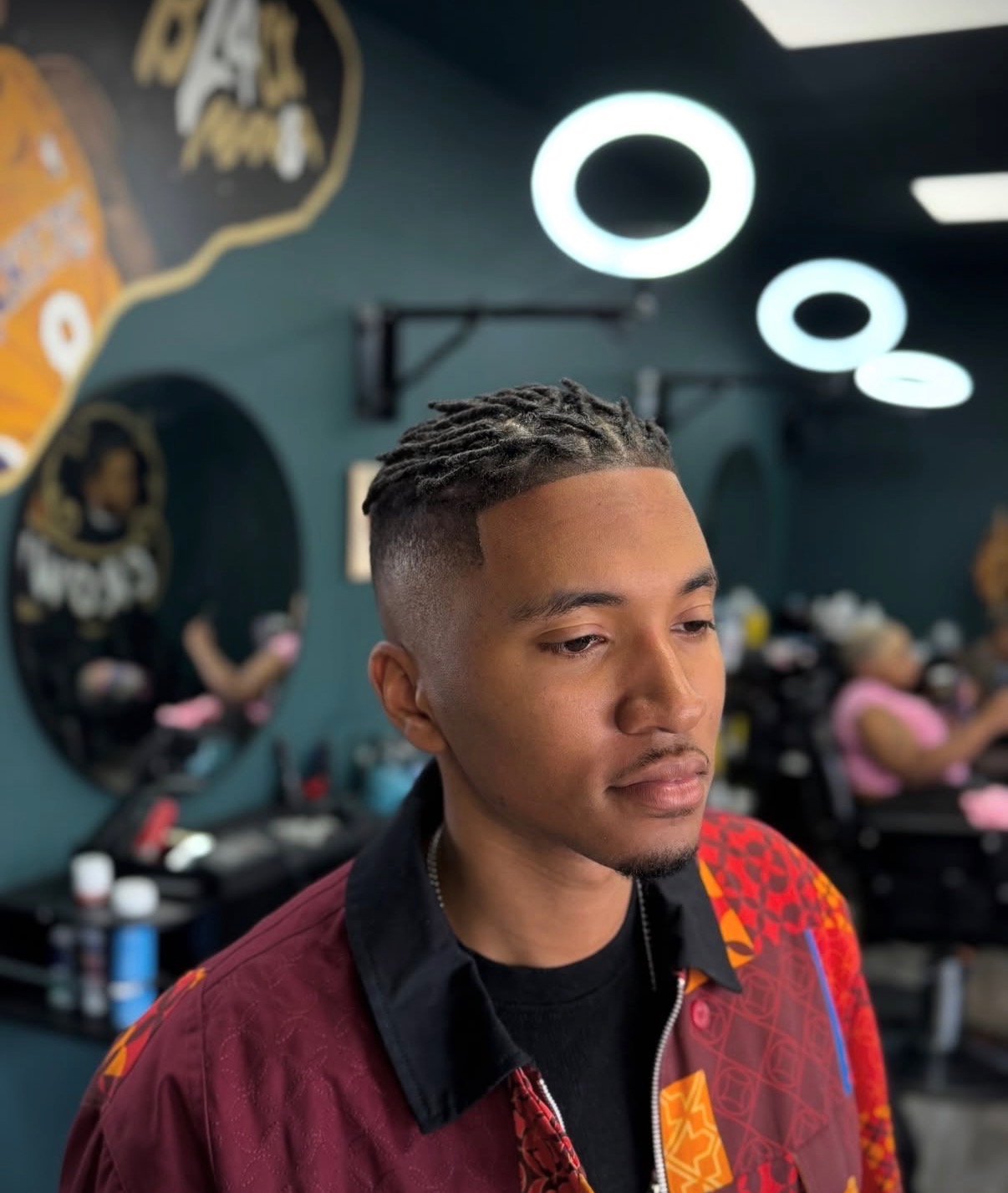 Locs with a clean taper fade